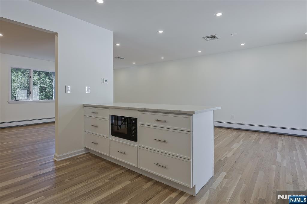 18 Ruth Lane Demarest, NJ 07627 - Photo 10 of 35 a kitchen with stainless steel appliances a large window and a refrigerator