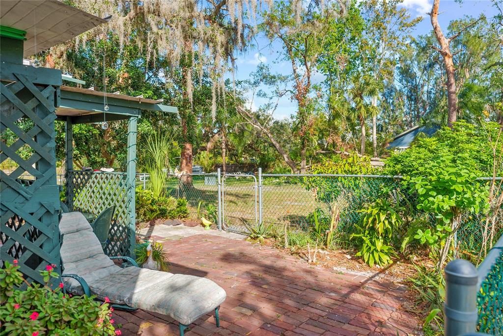 1285 Hagle Park Road Bradenton, FL 34212 - Photo 27 of 74 a backyard of a house with lots of green space and fountain