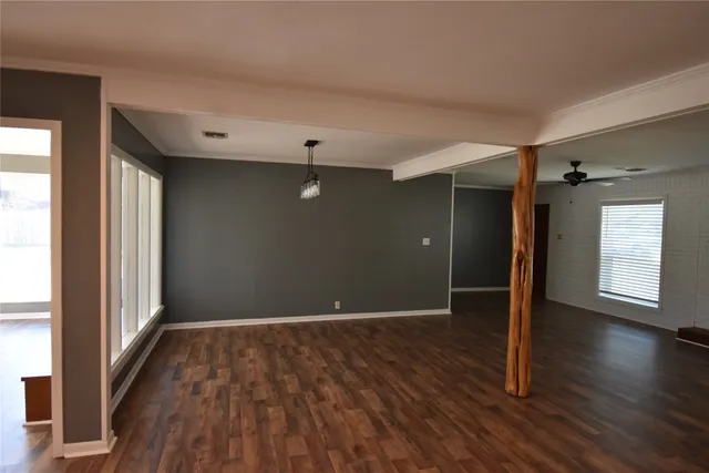 a kitchen with a sink appliances cabinets and a large window