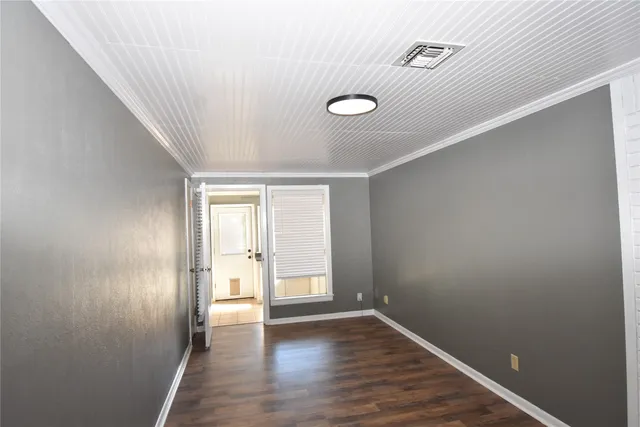 an empty room with a ceiling fan and window