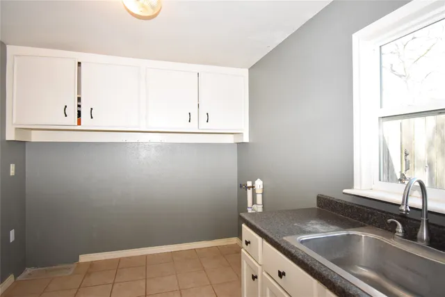 a kitchen with a sink and a large window