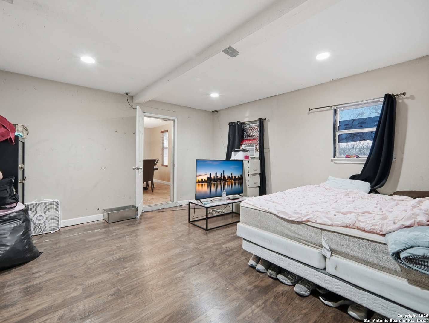 17525 Benton City Road Von Ormy, TX 78073 - Photo 14 of 36 a bedroom with a bed and a flat screen tv