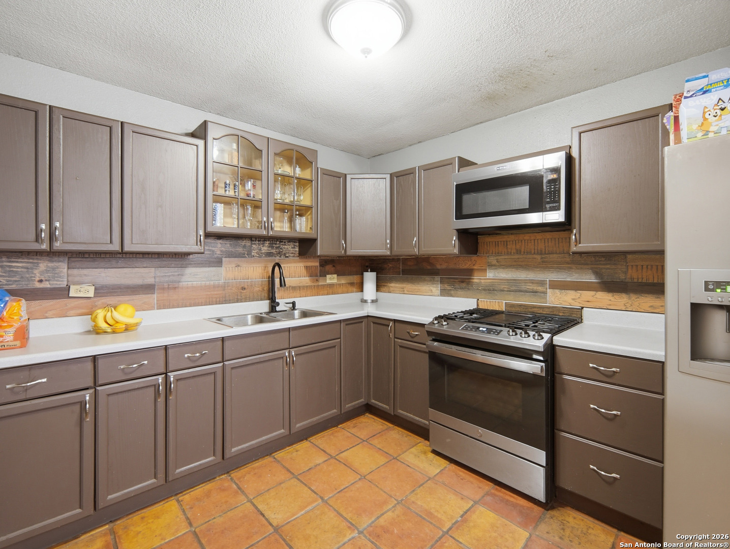 17525 Benton City Road Von Ormy, TX 78073 - Photo 10 of 36 a kitchen with stainless steel appliances granite countertop a sink and cabinets