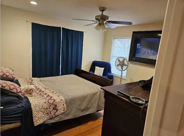 a bedroom with a bed and a mirror