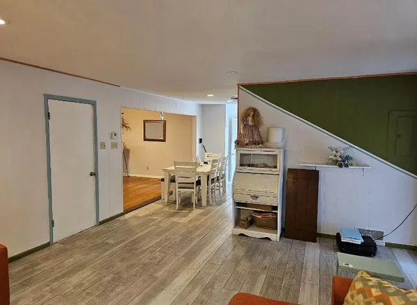 a view of a livingroom with furniture and a flat screen tv