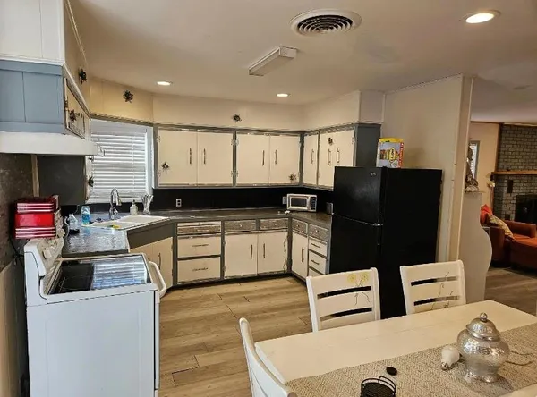a kitchen with stainless steel appliances kitchen island granite countertop a refrigerator and a stove