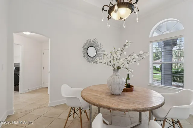 a view of a dining room with furniture and chandelier