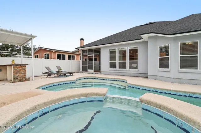 a house with swimming pool in front of it