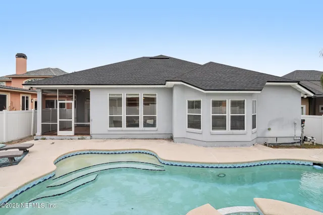 a view of a house with swimming pool and sitting area