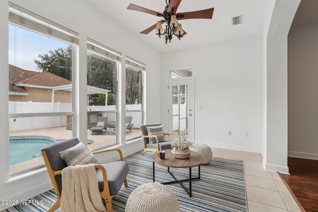 a view of a house with swimming pool and sitting area