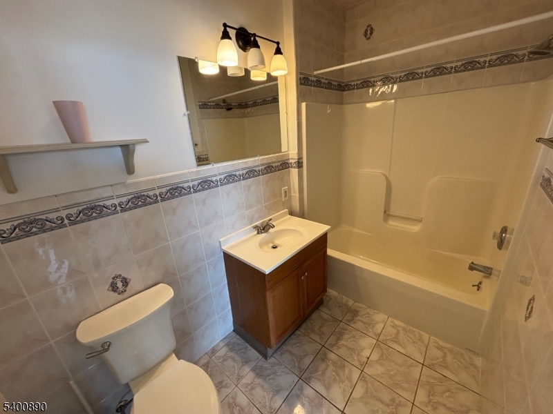 35 Wall Street, Unit 3 Oxford, NJ 07863 - Photo 10 of 12 a bathroom with a sink a toilet and shower