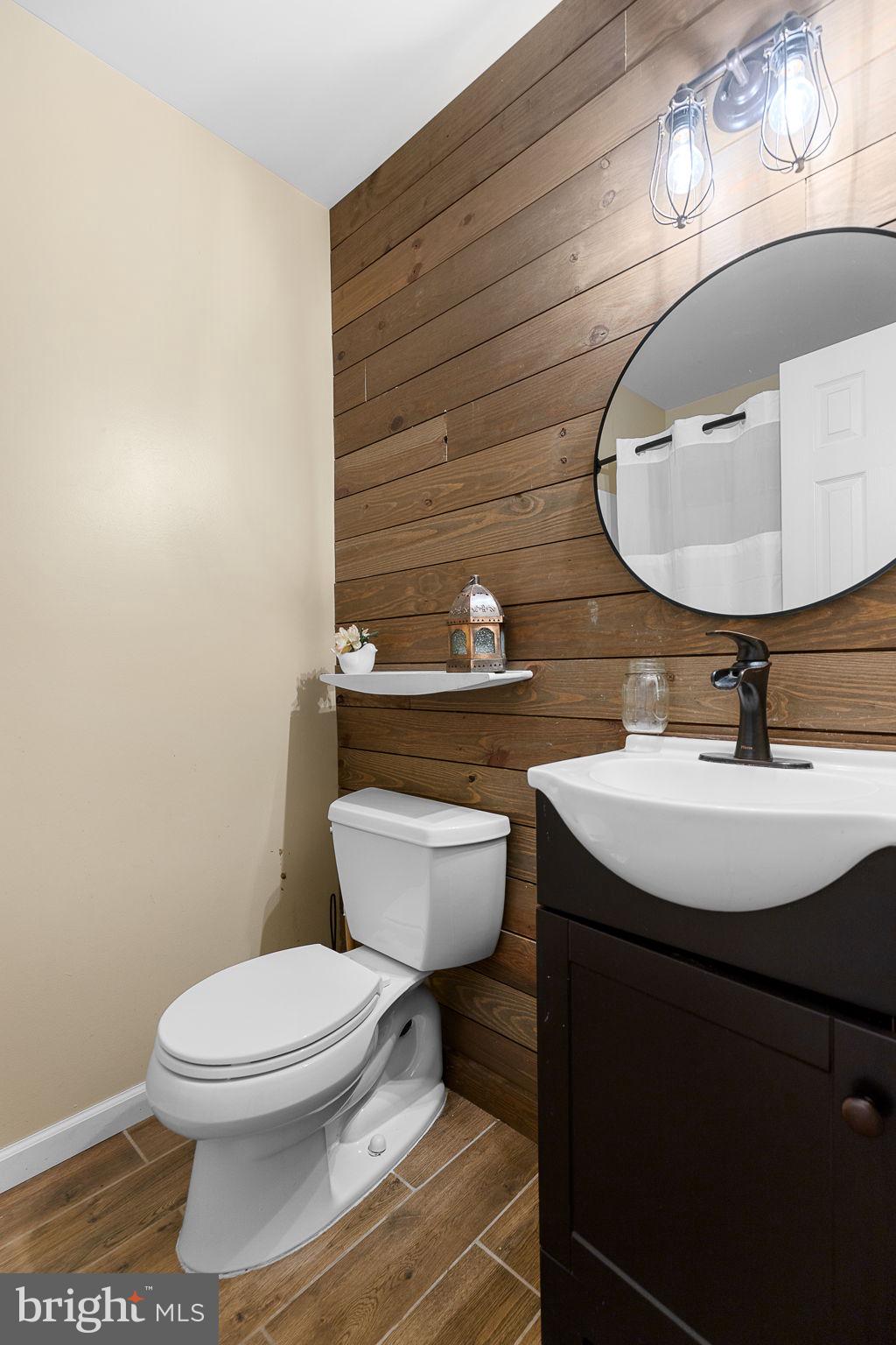 6199 Curtis Circle King George, VA 22485 - Photo 17 of 33 a bathroom with a sink toilet and mirror