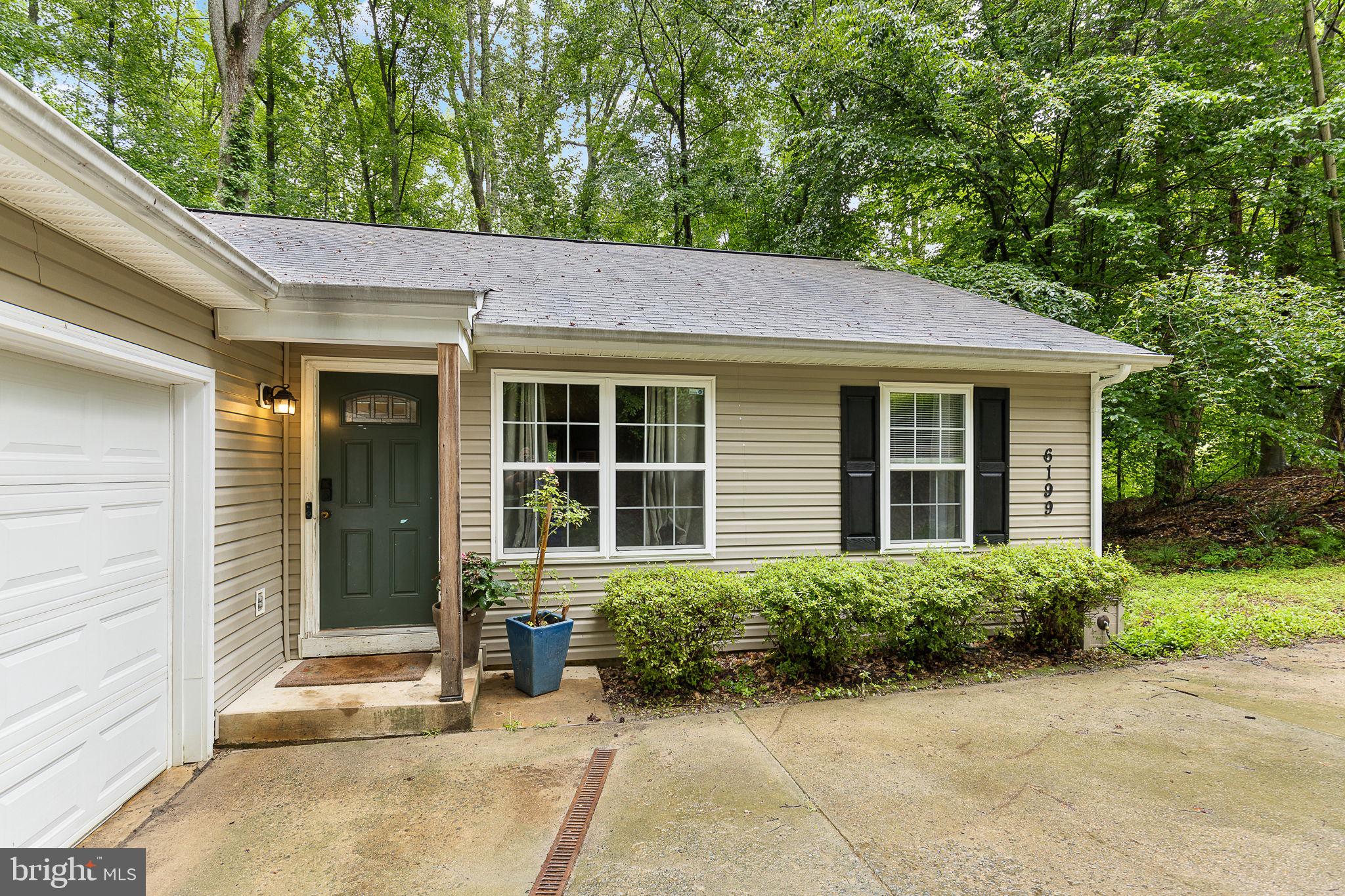 6199 Curtis Circle King George, VA 22485 - Photo 2 of 33 a backyard of a house with plants and trees