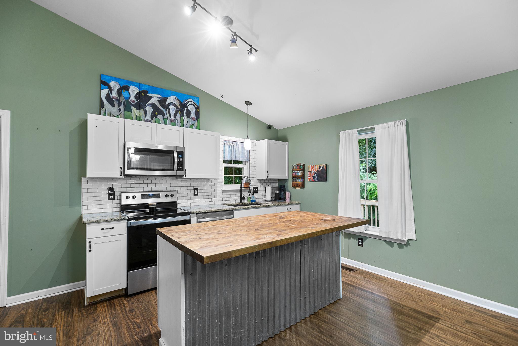 6199 Curtis Circle King George, VA 22485 - Photo 8 of 33 a kitchen with stainless steel appliances granite countertop a stove top oven a sink dishwasher and a microwave oven on the wooden floor