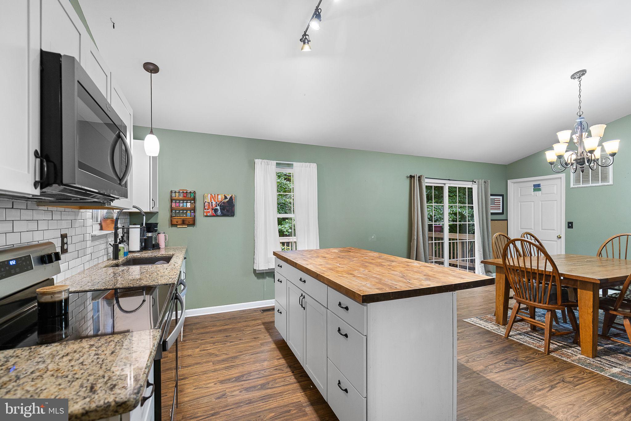 6199 Curtis Circle King George, VA 22485 - Photo 9 of 33 a open kitchen with stainless steel appliances granite countertop a stove and a wooden floors