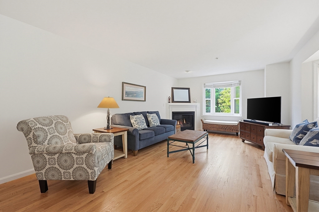 3002 Maple Brook Road, Unit 3002 Bellingham, MA 02019 - Photo 9 of 42 a living room with furniture a flat screen tv and a window