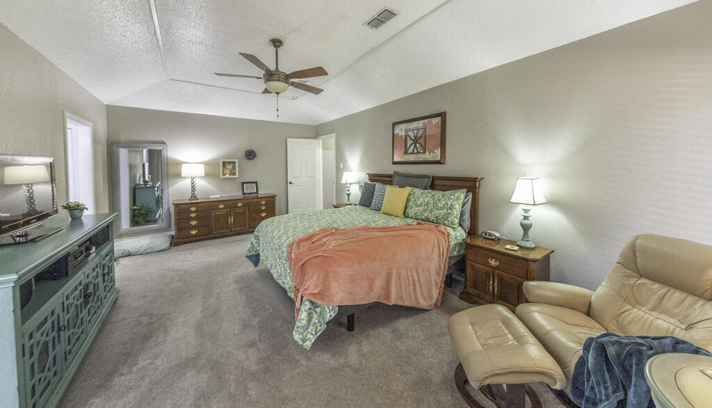 3620 93rd Street Lubbock, TX 79423 - Photo 20 of 33 a bedroom with furniture and a chandelier