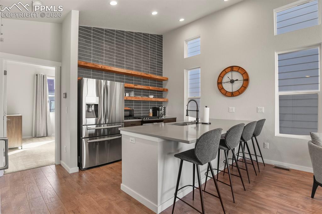 11314 Modern Meadow Loop Colorado Springs, CO 80921 - Photo 10 of 30 a kitchen with stainless steel appliances granite countertop a table chairs a stove and a refrigerator
