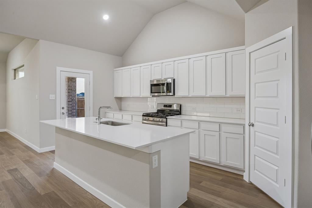 1404 Companero Street Haslet, TX 76052 - Photo 7 of 40 Kitchen in the Wimbledon home plan by Trophy Signature Homes – REPRESENTATIVE PHOTO