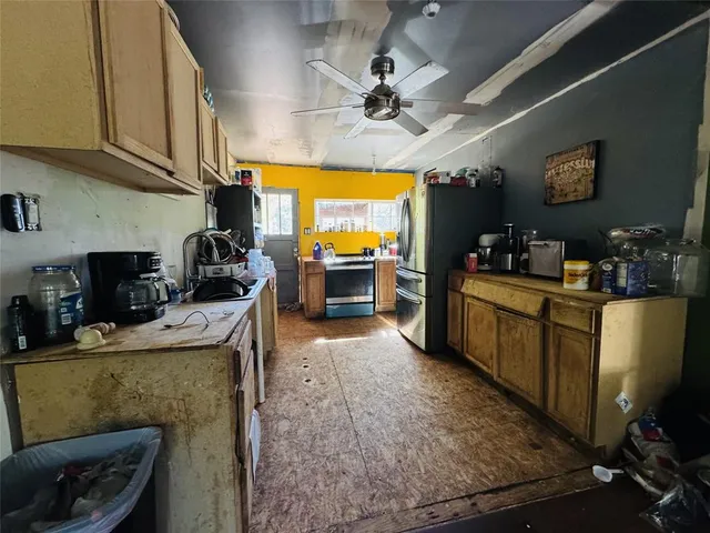 a kitchen with counter top space and stainless steel appliances