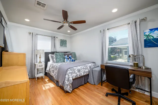 a bed room with a bed window and a desk
