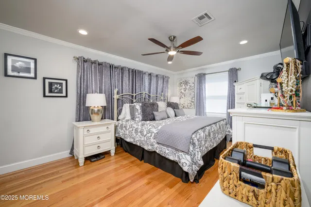 a spacious bedroom with a bed and a ceiling fan