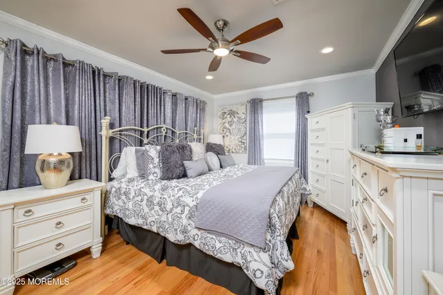 a spacious bedroom with a bed and a dresser in it