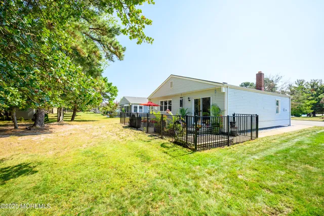 a view of a house with backyard porch and sitting area