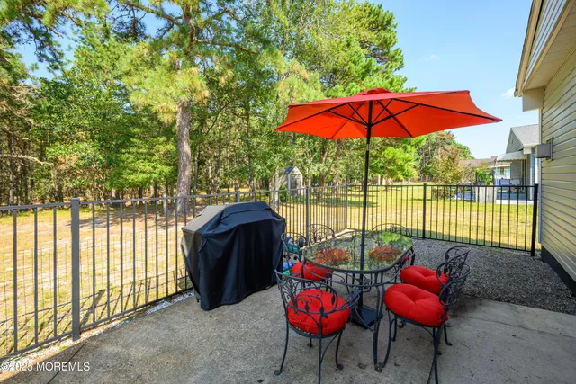 an outdoor sitting area with furniture and umbrella