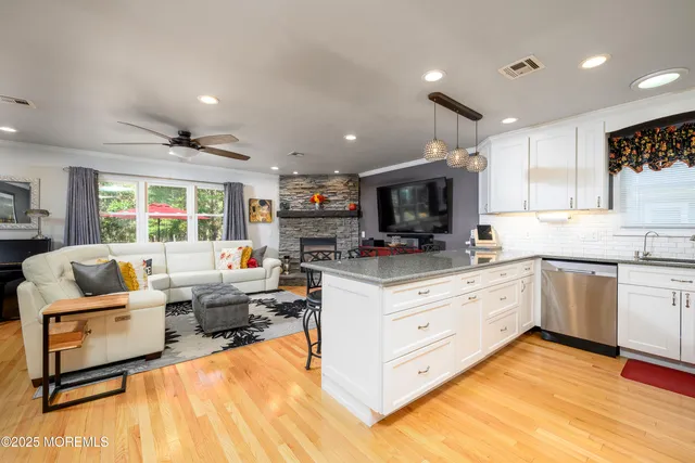 a living room with kitchen island furniture and a wooden floor