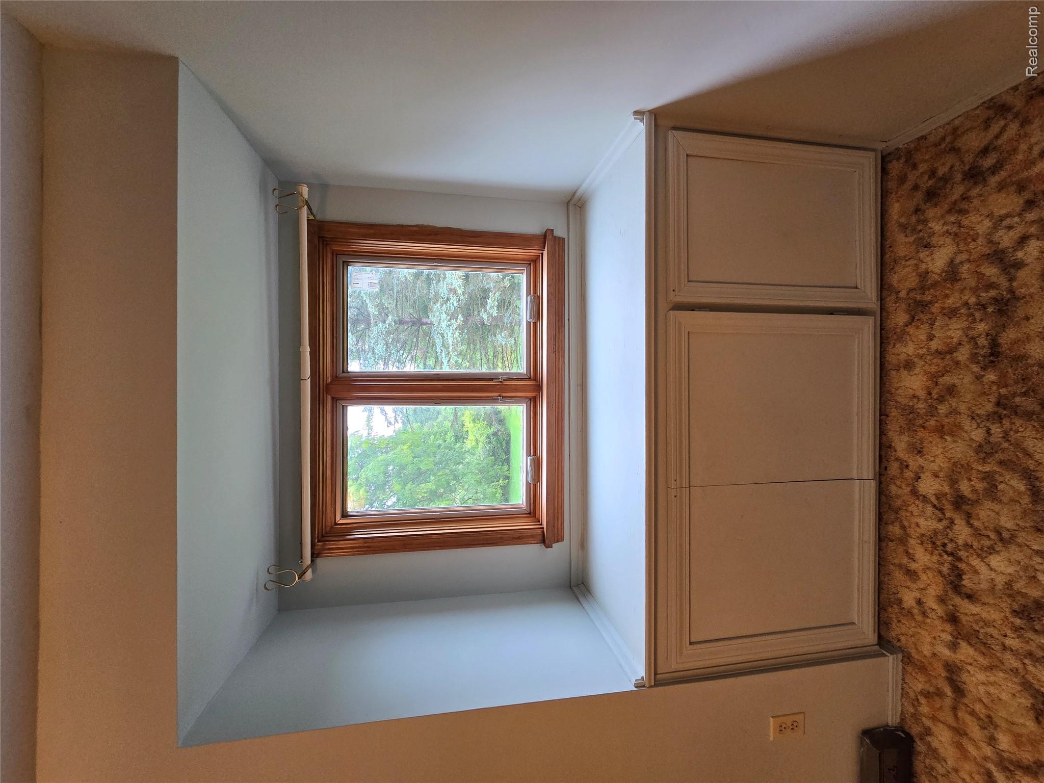 5282 McIntyre Road North Street, MI 48049 - Photo 45 of 53 Built-in window seat with integrated cabinetry, wood-framed double window, and a light-colored countertop