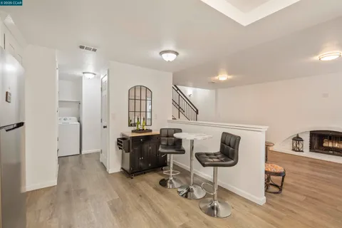 a view of a livingroom with furniture hardwood floor and a ceiling fan
