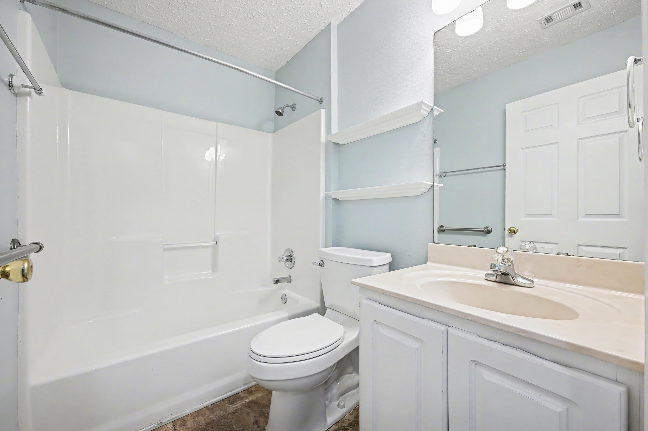 5127 Brookside Drive Pace, FL 32571 - Photo 19 of 25 a bathroom with a sink a toilet and shower
