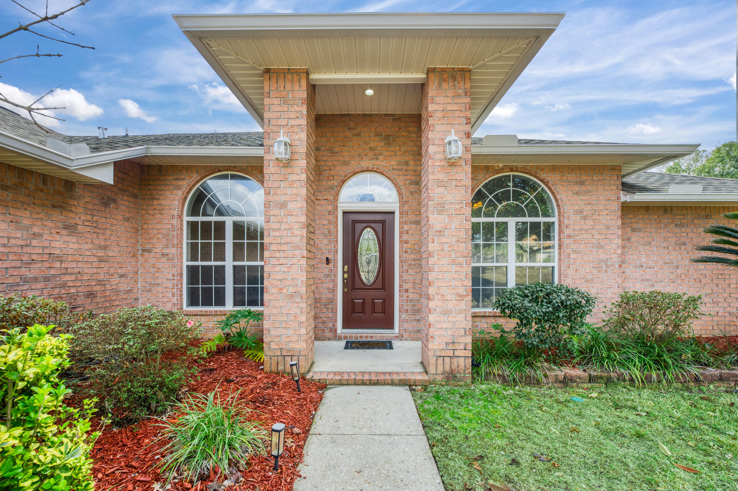 5127 Brookside Drive Pace, FL 32571 - Photo 2 of 25 a front view of a house with garden