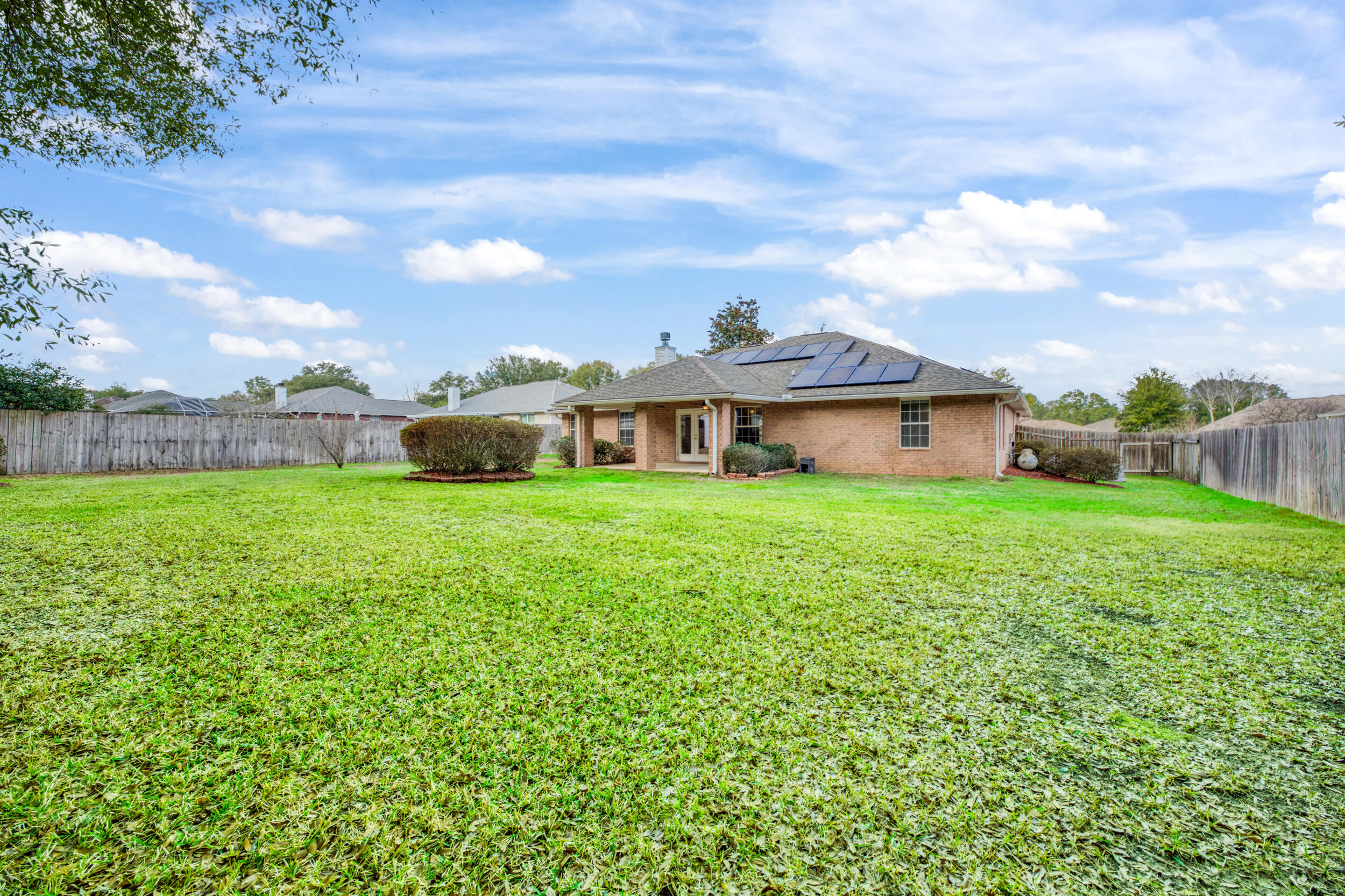 5127 Brookside Drive Pace, FL 32571 - Photo 23 of 25 a view of a house with a yard and sitting area