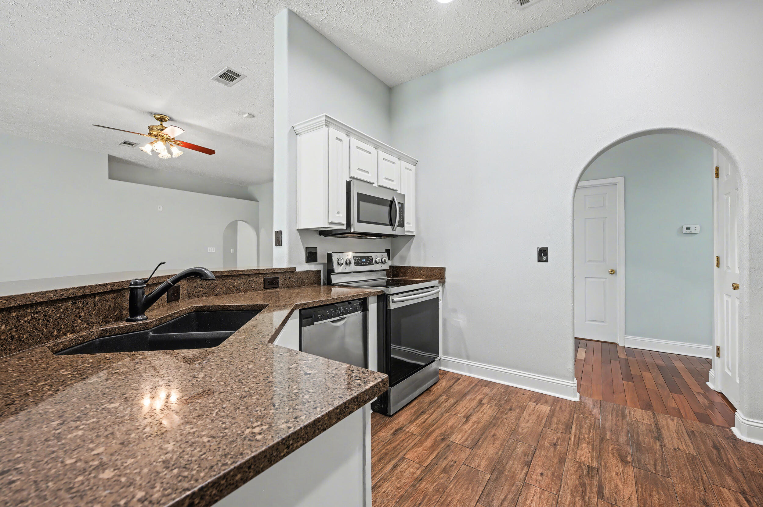 5127 Brookside Drive Pace, FL 32571 - Photo 5 of 25 a kitchen with a sink stove and refrigerator