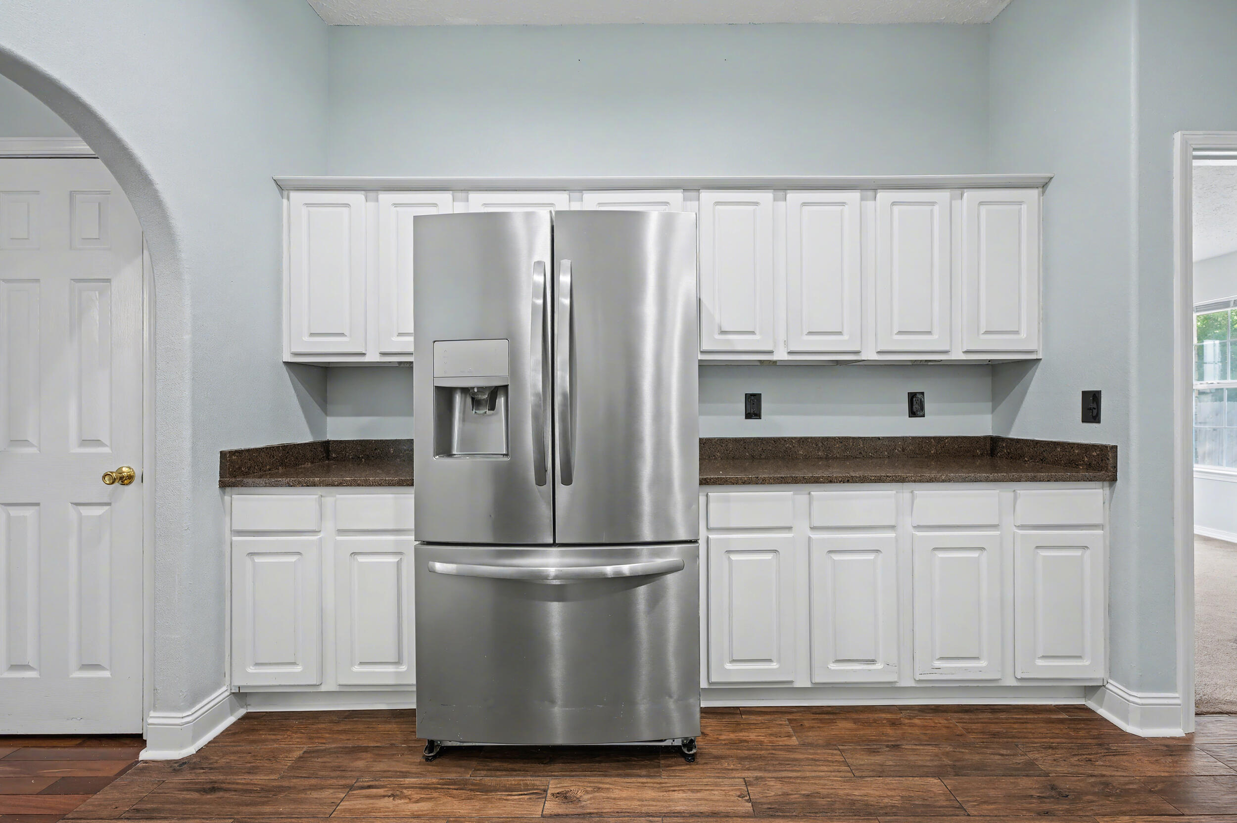 5127 Brookside Drive Pace, FL 32571 - Photo 6 of 25 a kitchen with appliances cabinets and wooden floor