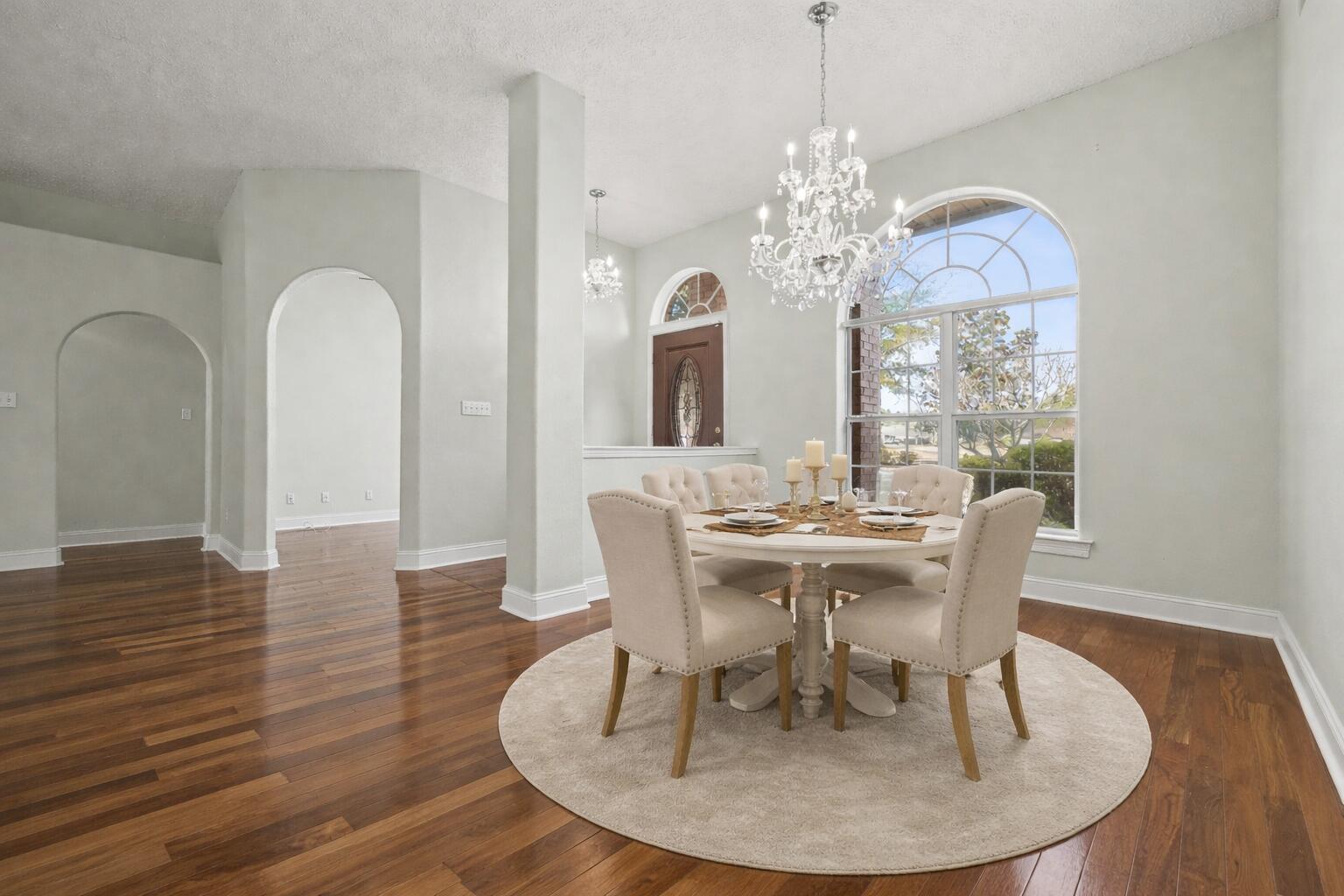 5127 Brookside Drive Pace, FL 32571 - Photo 7 of 25 a dining room with furniture a chandelier and wooden floor