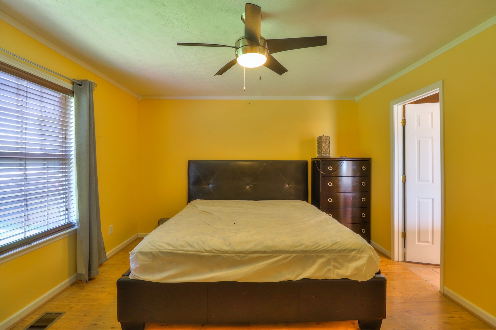 363 Cave Springs Road Lebanon, TN 37087 - Photo 17 of 28 a bed sitting in a bedroom next to a window