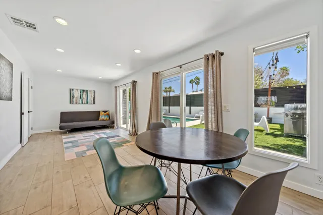a living room with furniture and a floor to ceiling window