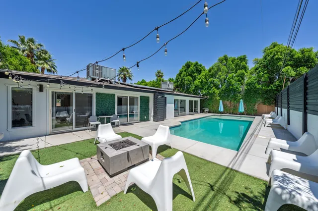 a view of a patio with couches chairs and potted plants
