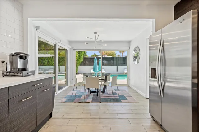 a dining table chair next to a window