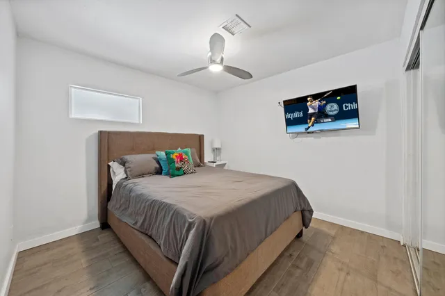 a bedroom with a bed and a chandelier