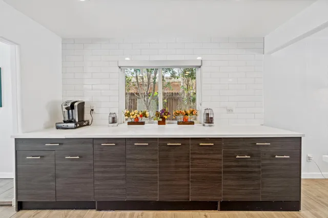 a bathroom with a sink a mirror and window