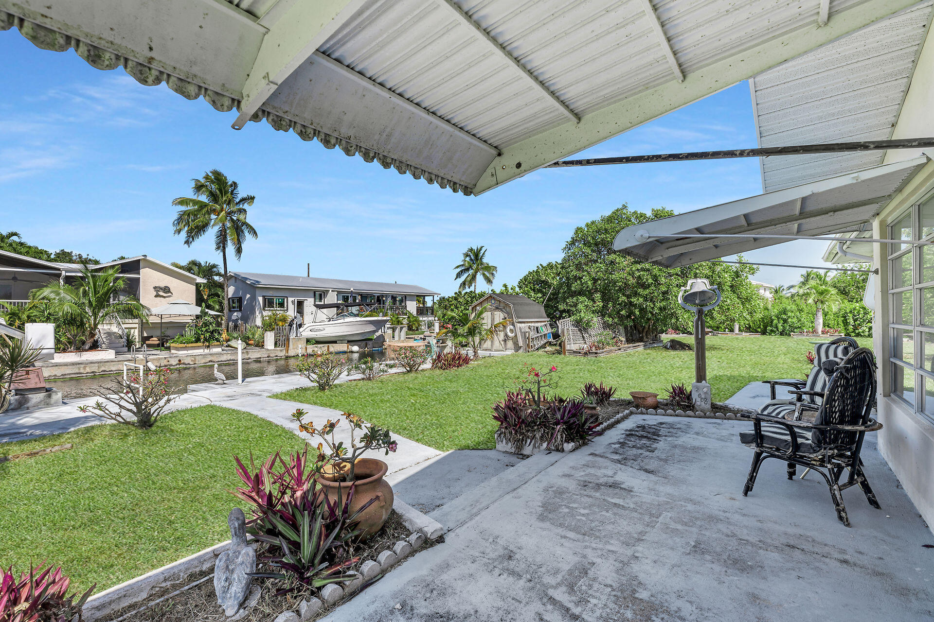 30361 Harding Road Big Pine Key, FL 33043 - Photo 18 of 33 a view of a porch with chairs and backyard