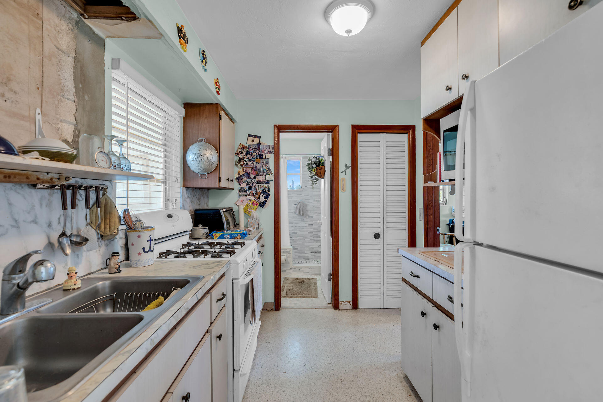 30361 Harding Road Big Pine Key, FL 33043 - Photo 24 of 33 a kitchen that has a sink a stove and a refrigerator