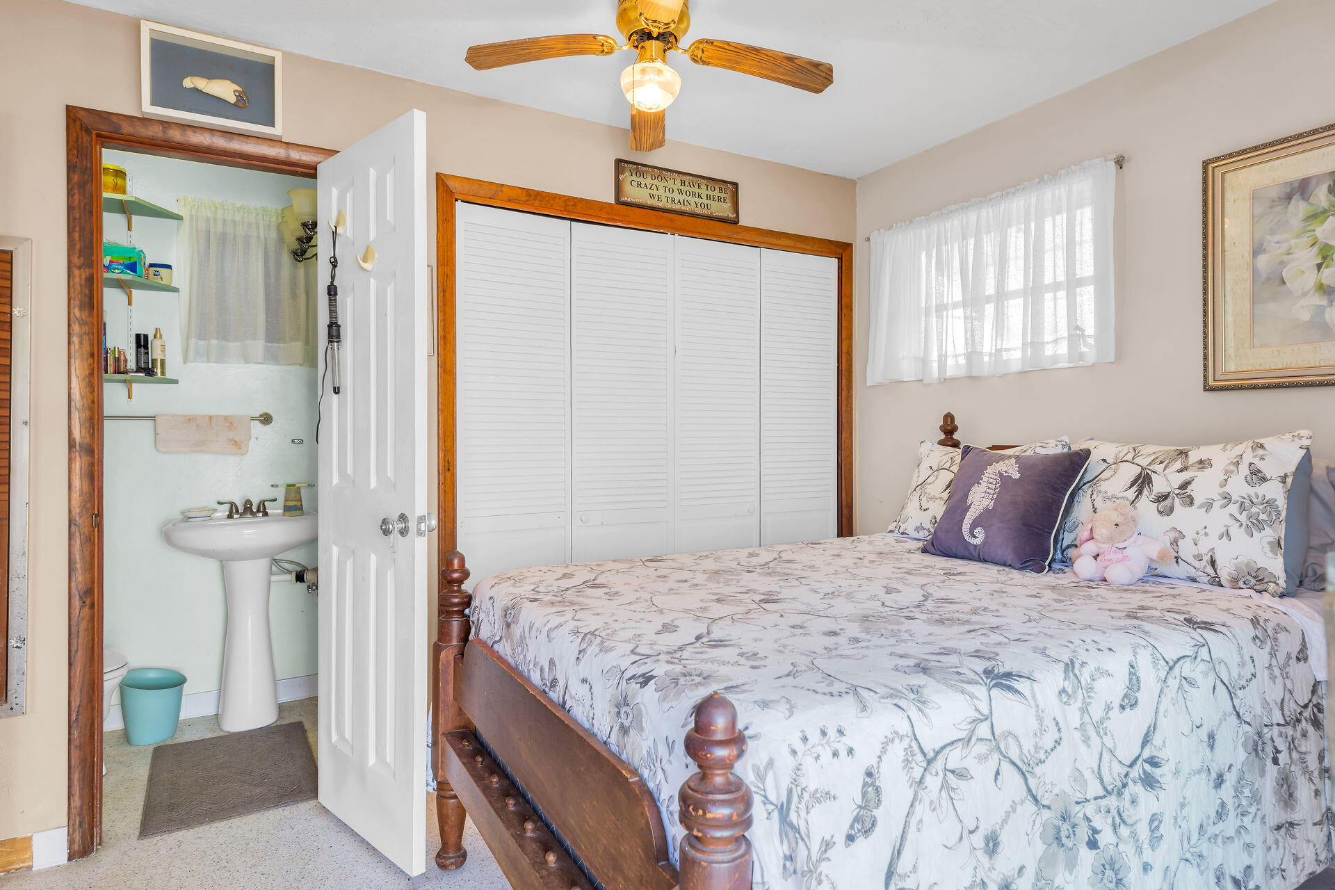 30361 Harding Road Big Pine Key, FL 33043 - Photo 28 of 33 a bedroom with a bed and a chandelier