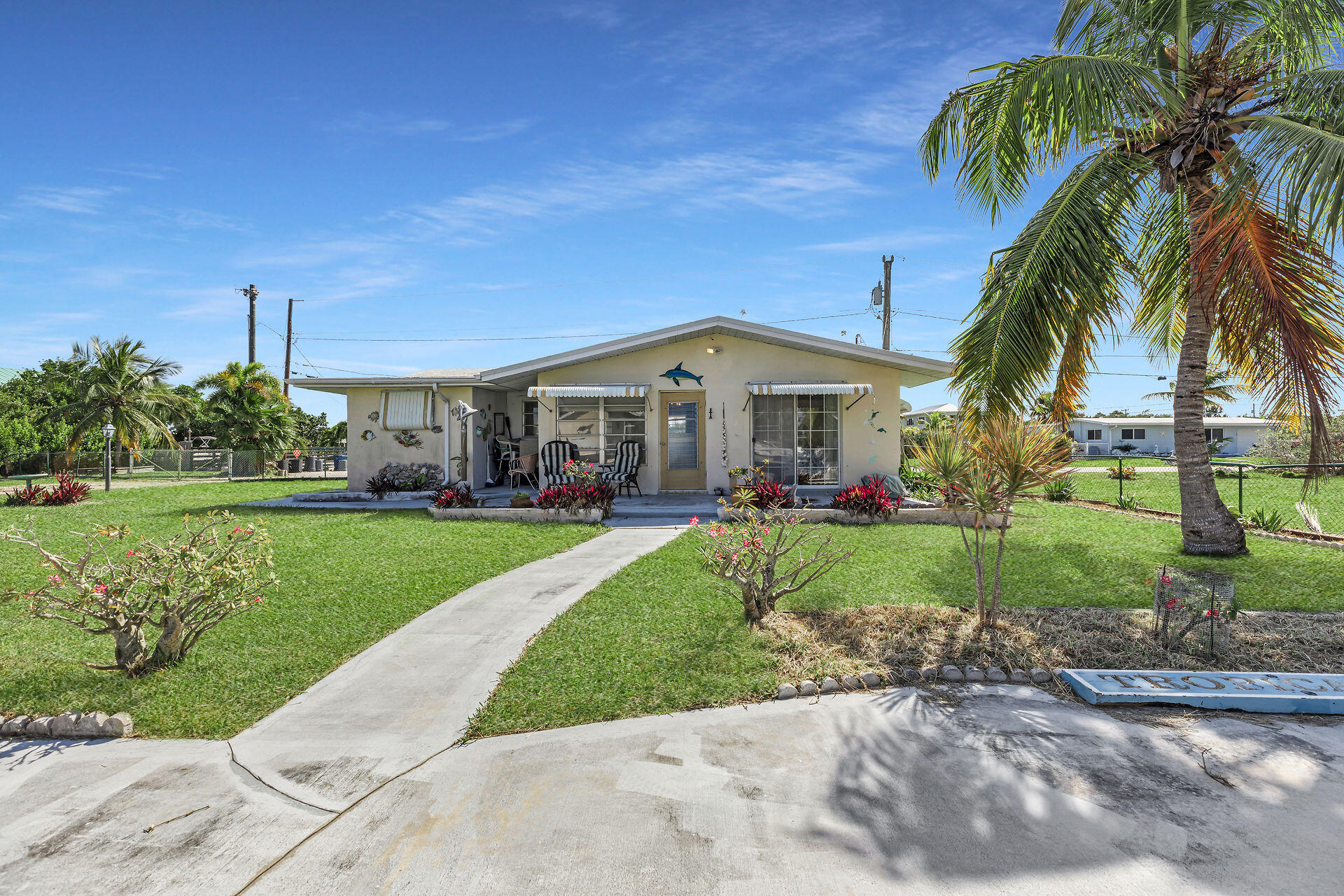 30361 Harding Road Big Pine Key, FL 33043 - Photo 3 of 33 a view of a white house with a big yard and potted plants