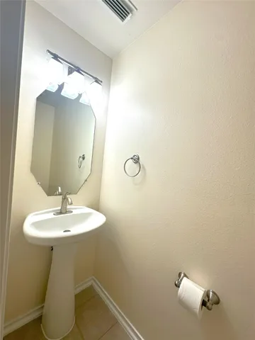 a white toilet sitting next to a shower