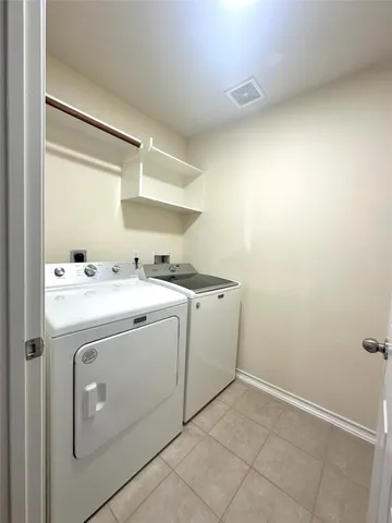 an empty room with wooden floor and a ceiling fan